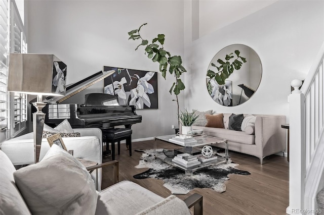 living room with a high ceiling and hardwood / wood-style floors