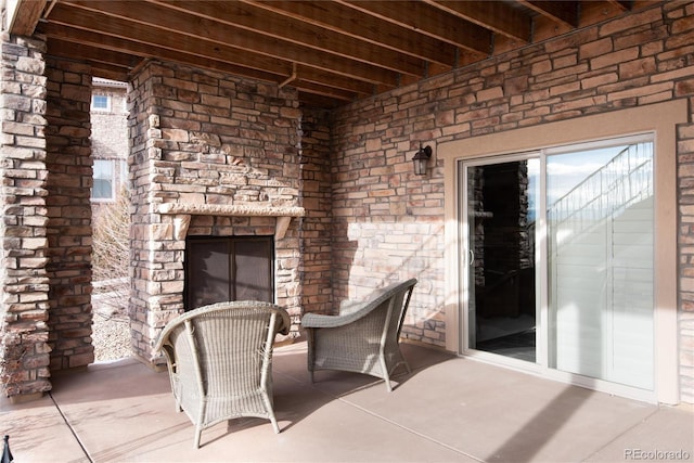 view of patio / terrace featuring exterior fireplace