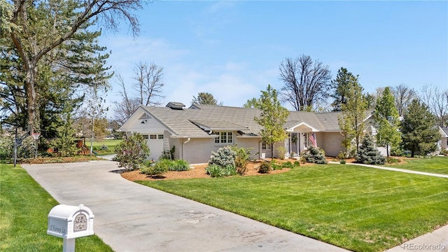 21 Fairway Ln, Littleton, CO 80123 - view of front of home featuring concrete driveway, stucco siding, a front yard, and a garage