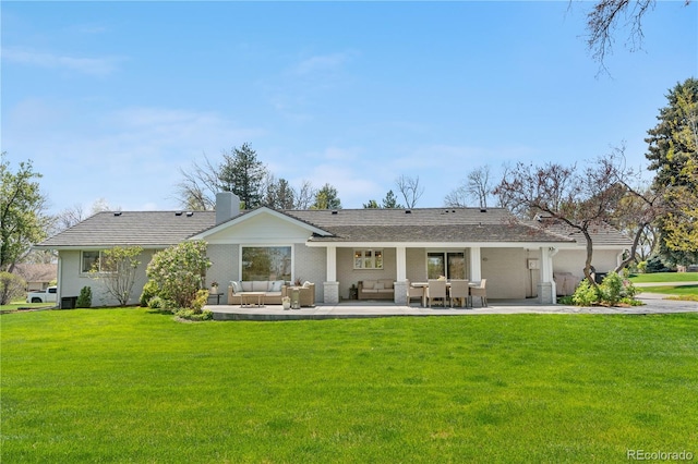 21 Fairway Ln, Littleton, CO 80123 - back of house featuring an outdoor living space, a yard, a chimney, and a patio area