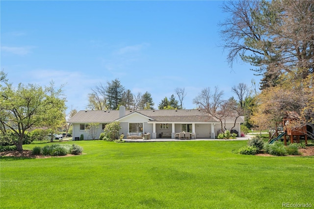 21 Fairway Ln, Littleton, CO 80123 - back of house featuring a yard, a patio area, driveway, and a chimney