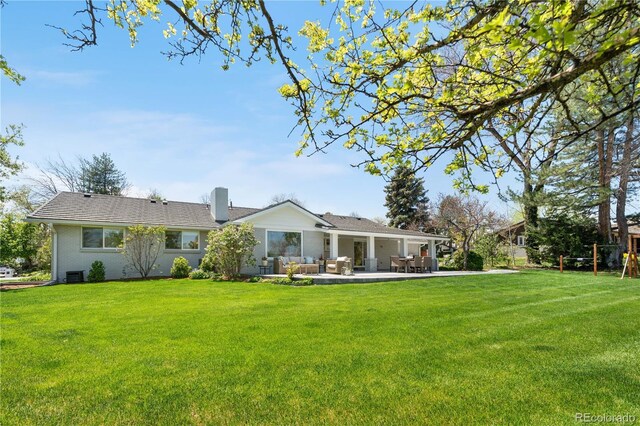21 Fairway Ln, Littleton, CO 80123 - back of house with a patio area, a yard, and a chimney