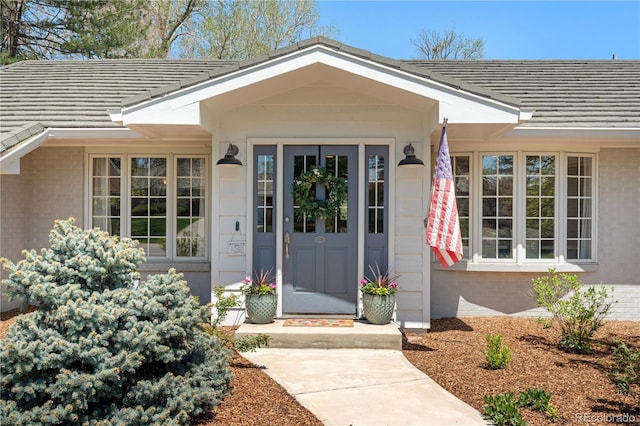 21 Fairway Ln, Littleton, CO 80123 - doorway to property featuring brick siding and a tiled roof