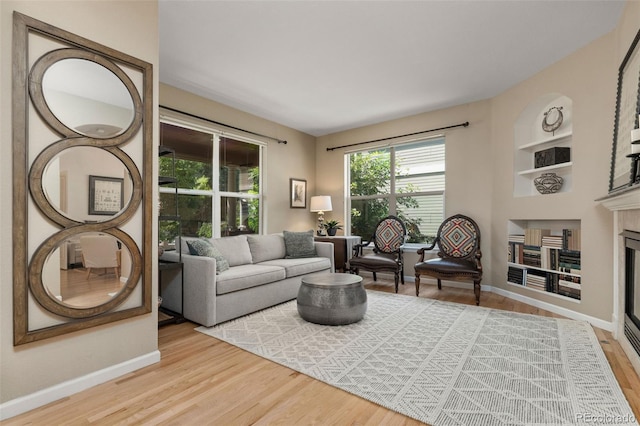 3670 Wolff St, Denver, CO 80212 - living area with a glass covered fireplace, wood finished floors, and built in features