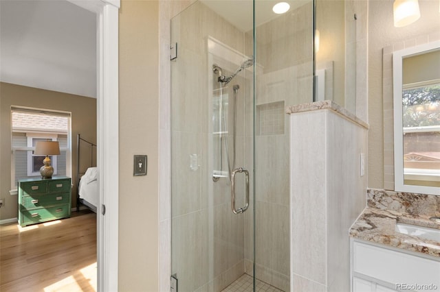 3670 Wolff St, Denver, CO 80212 - full bathroom with ensuite bath, a shower stall, wood finished floors, and vanity