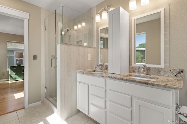 3670 Wolff St, Denver, CO 80212 - bathroom featuring a stall shower, double vanity, and tile patterned floors