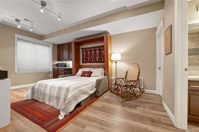 3670 Wolff St, Denver, CO 80212 - bedroom with light wood finished floors and ensuite bathroom