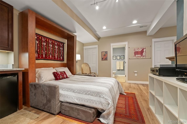3670 Wolff St, Denver, CO 80212 - bedroom featuring light wood-style floors, recessed lighting, ensuite bath, rail lighting, and refrigerator