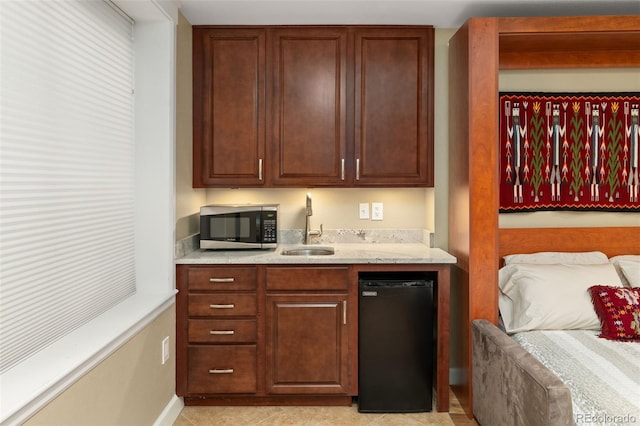 3670 Wolff St, Denver, CO 80212 - kitchen featuring stainless steel microwave, light stone countertops, and refrigerator