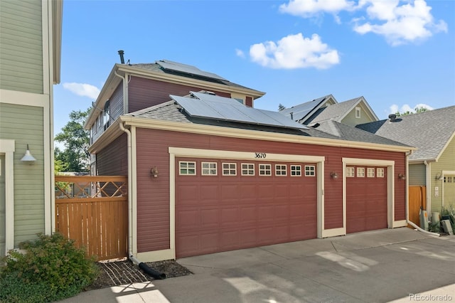 3670 Wolff St, Denver, CO 80212 - garage with roof mounted solar panels and driveway