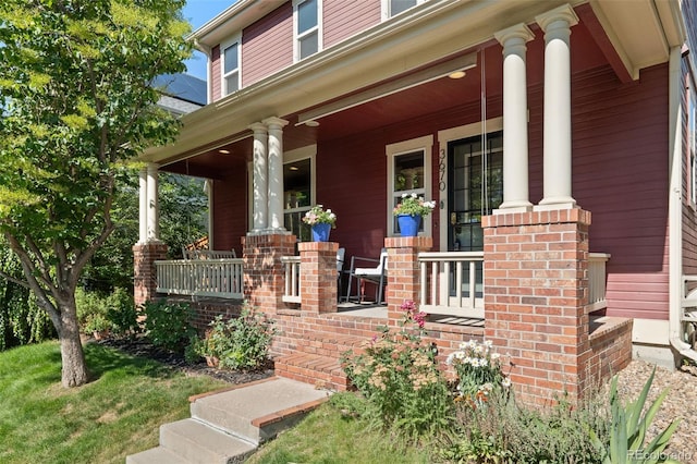 3670 Wolff St, Denver, CO 80212 - doorway to property with covered porch and brick siding