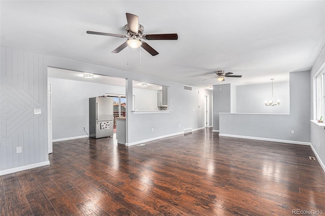 unfurnished living room with dark hardwood / wood-style floors and ceiling fan with notable chandelier