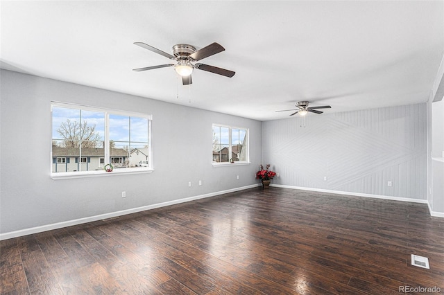 spare room with ceiling fan and dark hardwood / wood-style floors