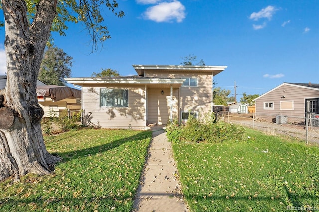 view of front facade featuring a front lawn and central AC unit