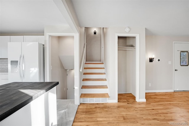 stairway with hardwood / wood-style floors