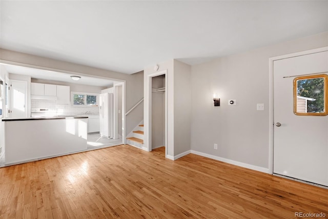 unfurnished living room with light hardwood / wood-style floors