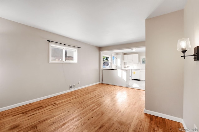 unfurnished room with light wood-type flooring