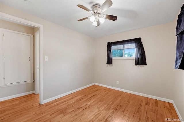 spare room featuring light hardwood / wood-style flooring and ceiling fan