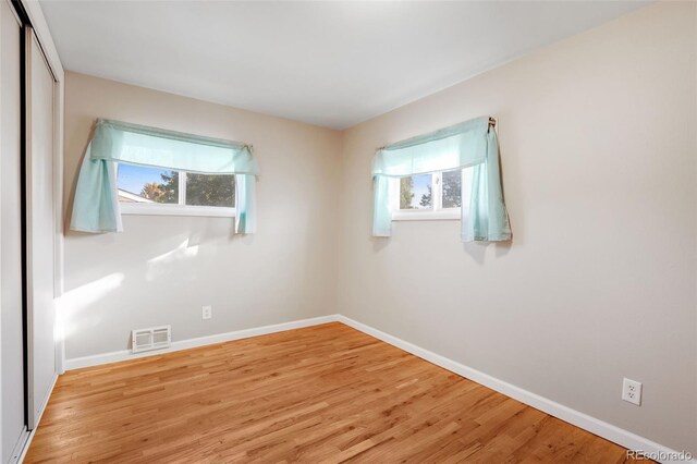 unfurnished room with light wood-type flooring