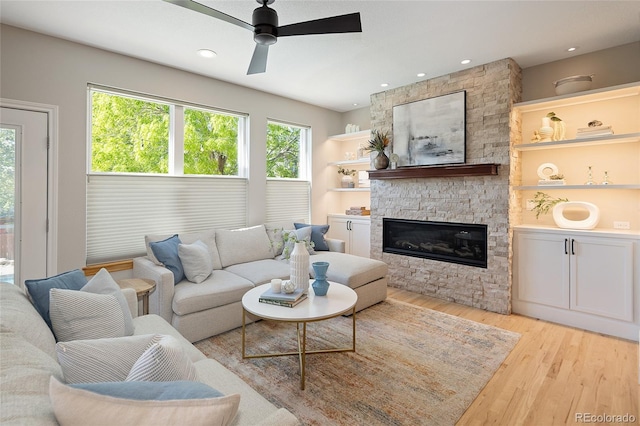 1996 Clipper Dr, Lafayette, CO 80026 - living area featuring light wood-style floors, ceiling fan, a stone fireplace, and recessed lighting