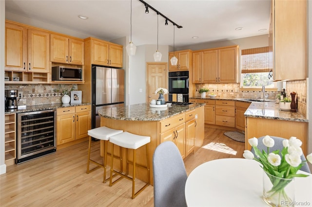 1996 Clipper Dr, Lafayette, CO 80026 - kitchen featuring beverage cooler, stainless steel appliances, a center island, a sink, and decorative backsplash