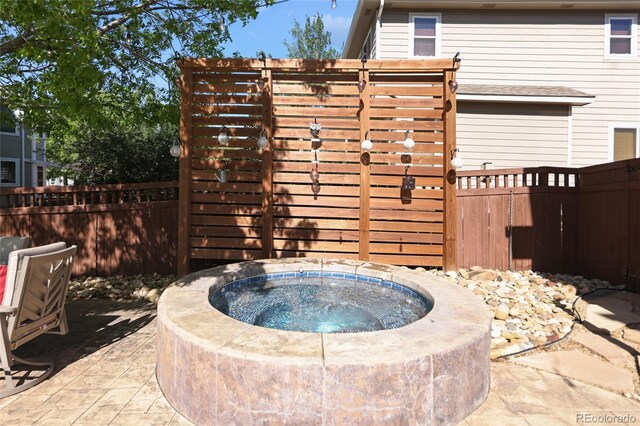 1996 Clipper Dr, Lafayette, CO 80026 - view of patio / terrace with an outdoor hot tub and fence