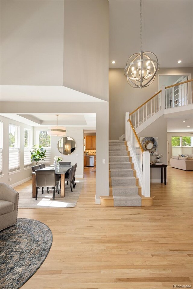 1996 Clipper Dr, Lafayette, CO 80026 - staircase with a towering ceiling, wood finished floors, a chandelier, recessed lighting, and baseboards