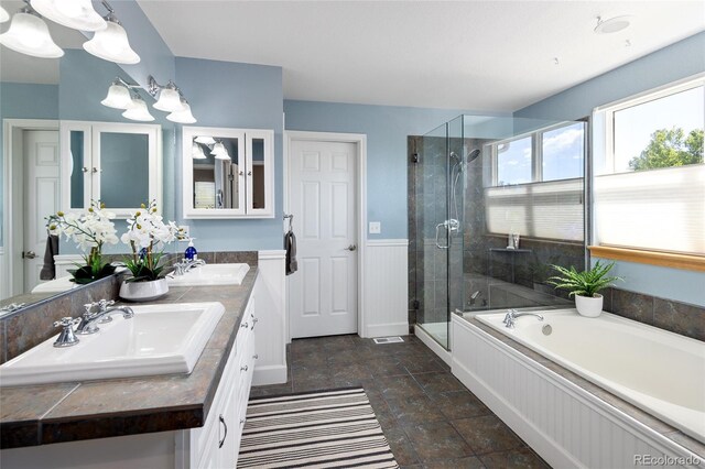 1996 Clipper Dr, Lafayette, CO 80026 - bathroom with stone finish floors, a stall shower, a bath, double vanity, and a chandelier