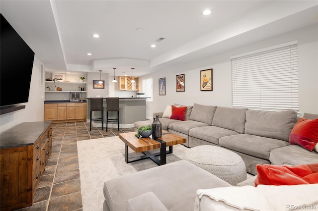 1996 Clipper Dr, Lafayette, CO 80026 - living room with a raised ceiling, recessed lighting, wet bar, and dark stone finish floors