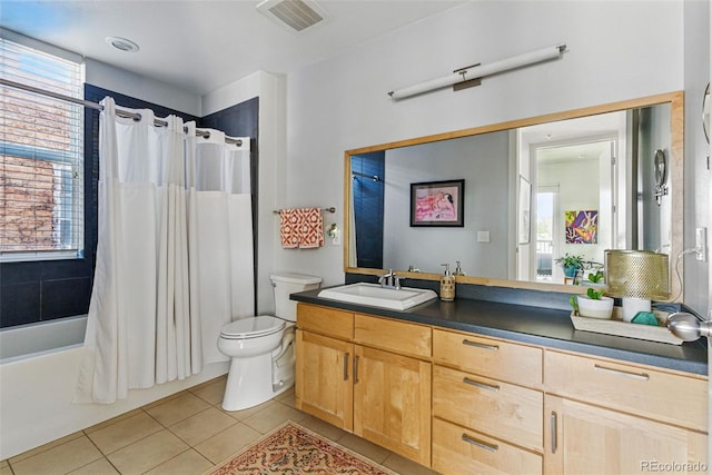 bathroom featuring vanity, visible vents, tile patterned floors, toilet, and shower / tub combo with curtain