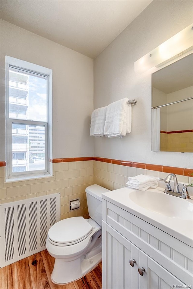 bathroom featuring vanity, radiator, toilet, and wood-type flooring