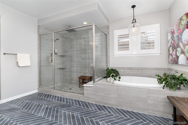 full bathroom featuring a shower stall and a garden tub