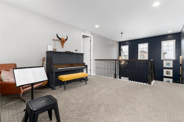 sitting room featuring an upstairs landing, recessed lighting, visible vents, and carpet floors