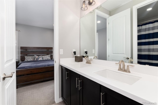 bathroom featuring recessed lighting, a sink, double vanity, and ensuite bathroom