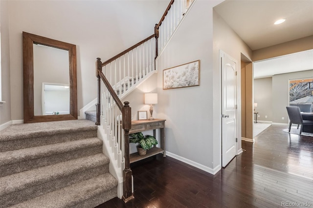 staircase with hardwood / wood-style flooring, recessed lighting, and baseboards