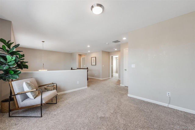 living area with recessed lighting, visible vents, baseboards, and light carpet