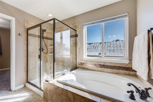 full bath with a bath, tile patterned flooring, a shower stall, and baseboards