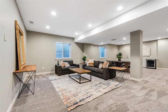 living room with wine cooler, visible vents, recessed lighting, and light carpet