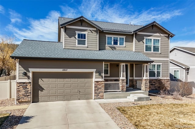 craftsman house featuring stone siding, covered porch, driveway, and a shingled roof