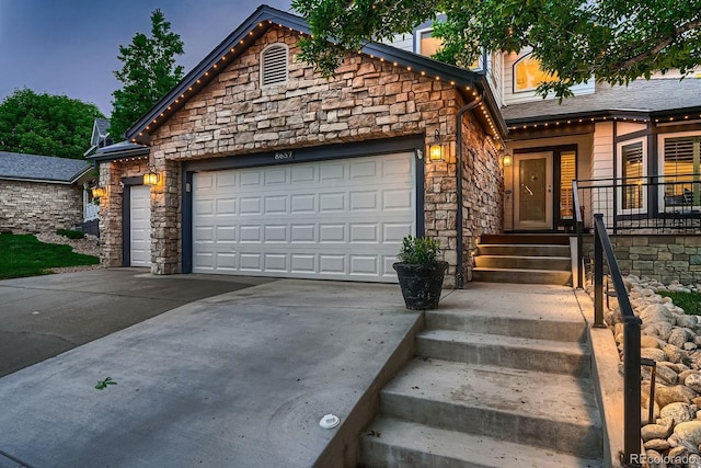 8657 Aberdeen Cir, Highlands Ranch, CO 80130 - view of front of home with stone siding, an attached garage, and concrete driveway