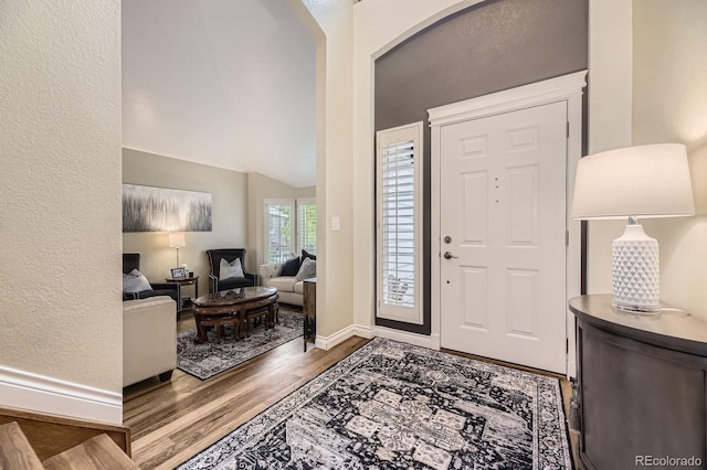 8657 Aberdeen Cir, Highlands Ranch, CO 80130 - entrance foyer featuring wood finished floors, baseboards, and vaulted ceiling