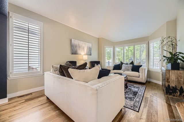 8657 Aberdeen Cir, Highlands Ranch, CO 80130 - living area featuring wood finished floors, lofted ceiling, and baseboards