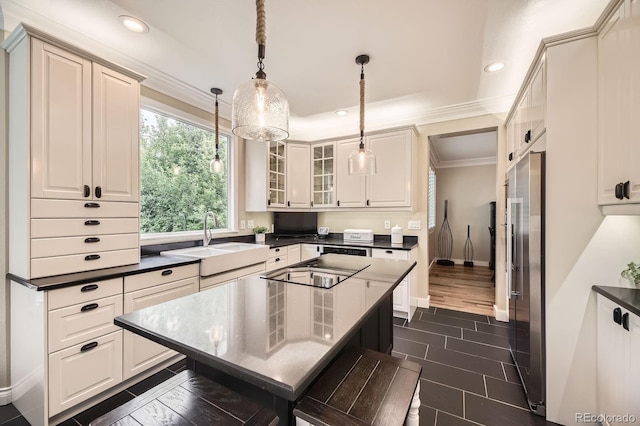 8657 Aberdeen Cir, Highlands Ranch, CO 80130 - kitchen featuring a sink, ornamental molding, dark countertops, glass insert cabinets, and high quality fridge