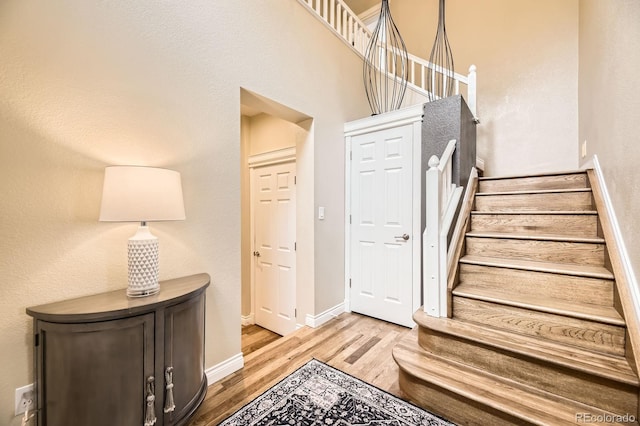 8657 Aberdeen Cir, Highlands Ranch, CO 80130 - entrance foyer with wood finished floors, baseboards, and stairs