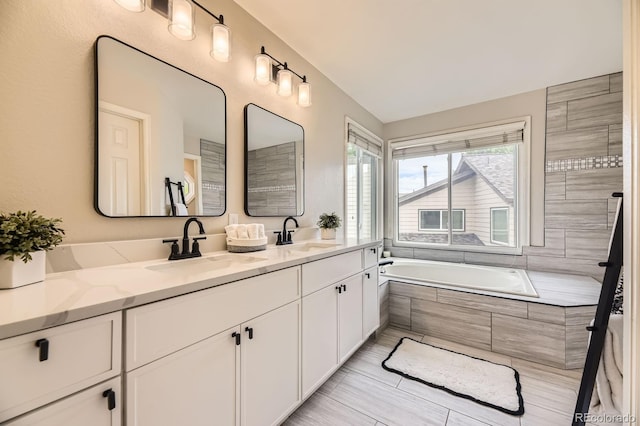 8657 Aberdeen Cir, Highlands Ranch, CO 80130 - bathroom with double vanity and tiled bath