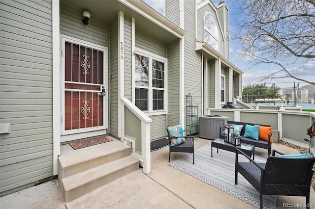 5875 W Asbury Pl, Lakewood, CO 80227 - doorway to property featuring an outdoor living space, a chimney, and cooling unit
