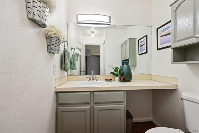 5875 W Asbury Pl, Lakewood, CO 80227 - bathroom with vanity, baseboards, and toilet