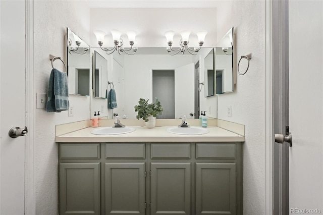 5875 W Asbury Pl, Lakewood, CO 80227 - bathroom featuring double vanity, a sink, and a textured wall