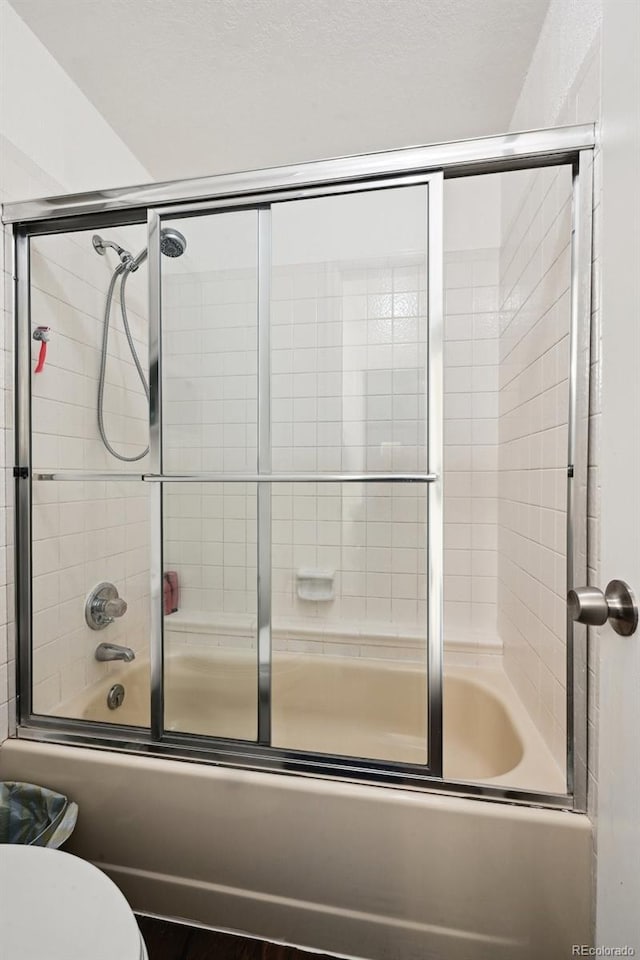 5875 W Asbury Pl, Lakewood, CO 80227 - bathroom featuring toilet and enclosed tub / shower combo