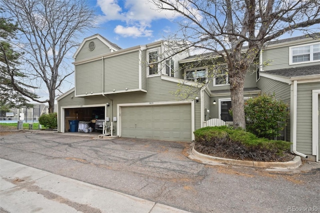 5875 W Asbury Pl, Lakewood, CO 80227 - townhome / multi-family property featuring an attached garage and driveway